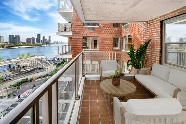 a balcony view with couple of couch
