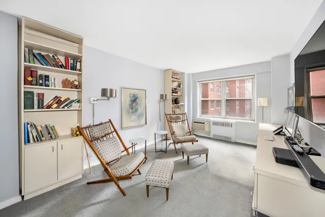 a living room with furniture and floor to ceiling window