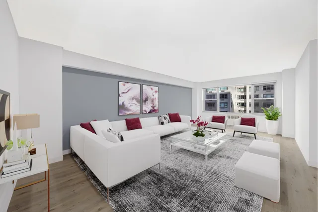 a living room with furniture and flowers