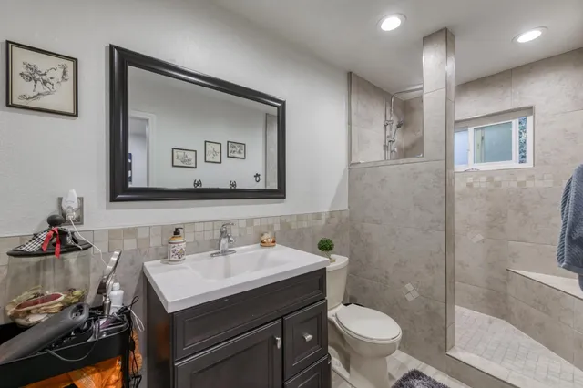 a bathroom with a toilet sink and mirror
