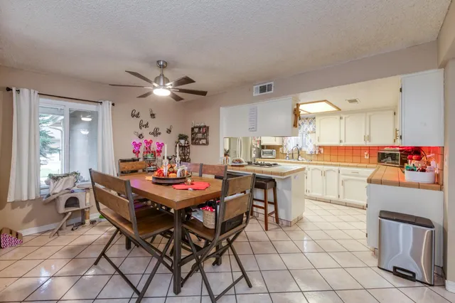 a dining hall with a dining table and chairs