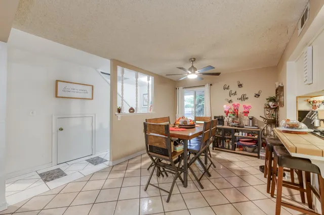 a view of a dining room with furniture and chandelier