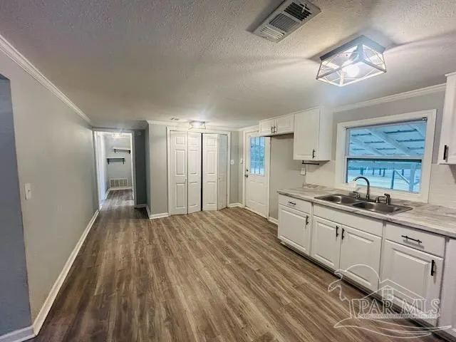 a large kitchen with kitchen island a stove a sink dishwasher a refrigerator and wooden floor