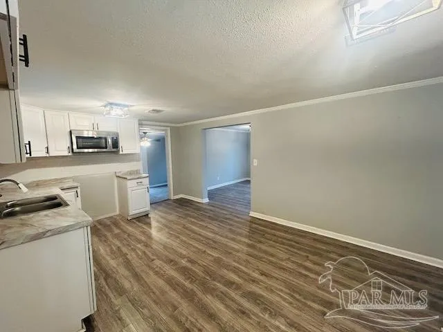 a kitchen with granite countertop a stove and a refrigerator
