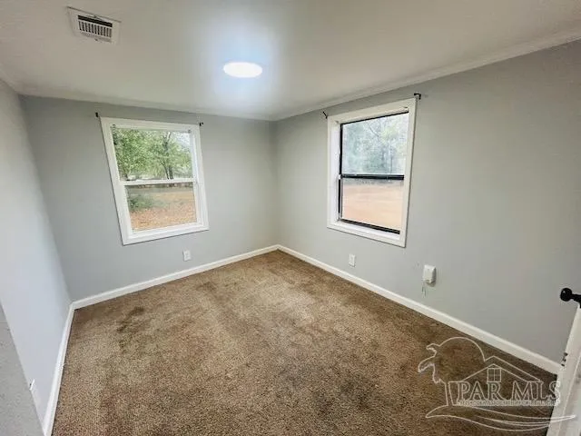 a view of an empty room with windows