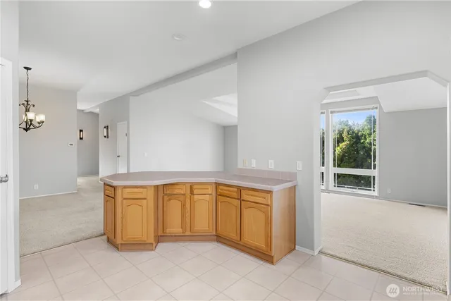 a view of an empty room with window and cabinet