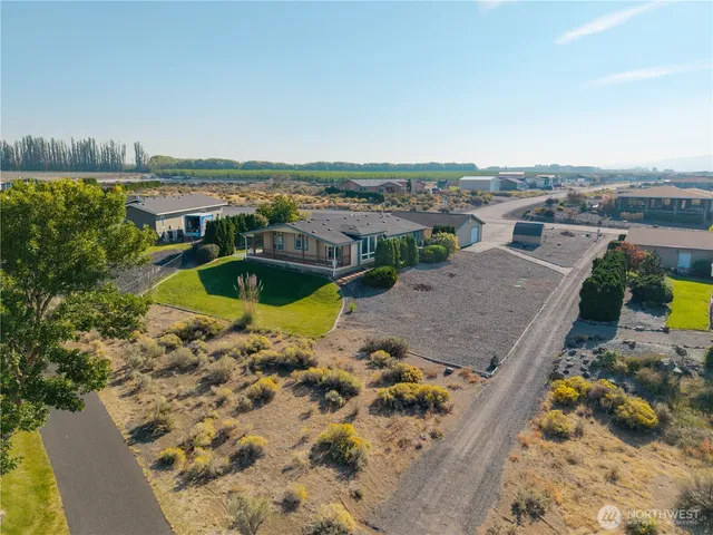 an aerial view of a house with a yard