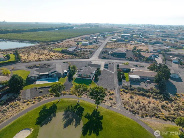 an aerial view of residential houses with outdoor space and river
