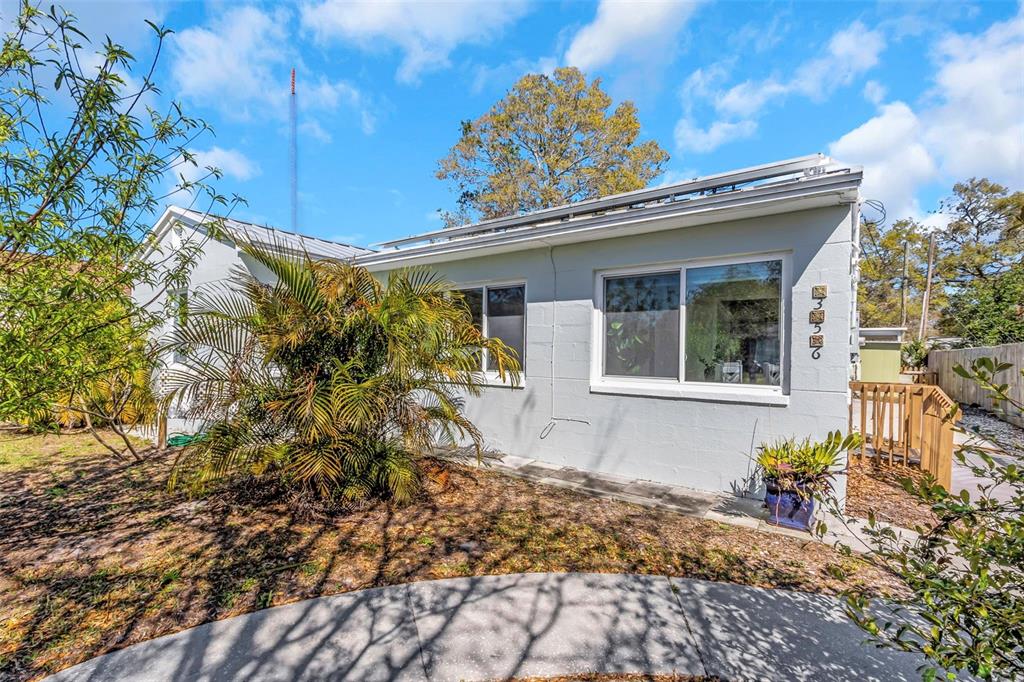356 Ridge Road Southwest Largo, FL 33770 - Photo 1 of 1 a front view of a house with garden
