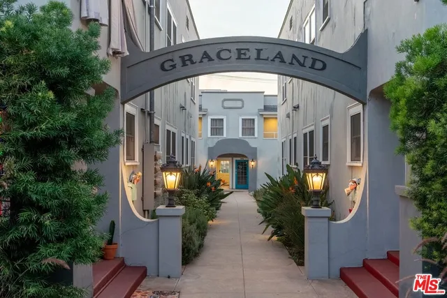 a dining room with furniture a chandelier and wooden floor