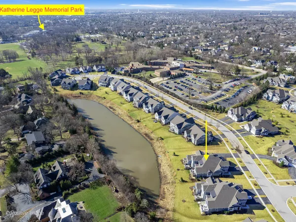 an aerial view of residential houses with yard