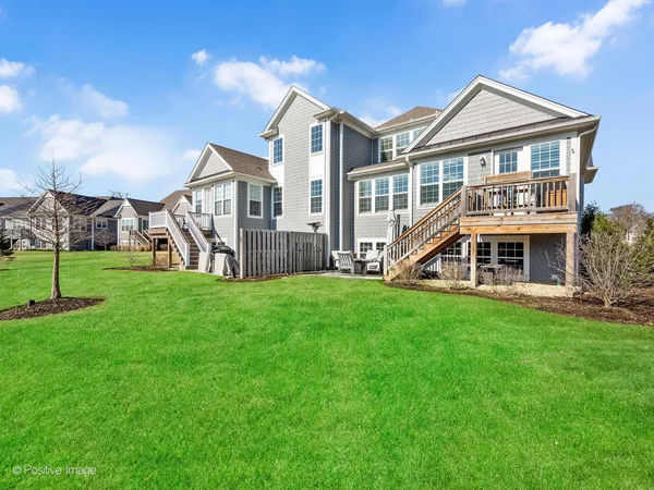 a view of a patio with lawn chairs next to a yard