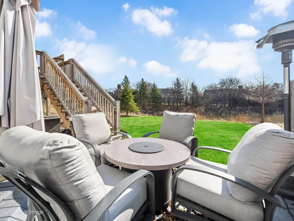 a view of a house with a yard and deck