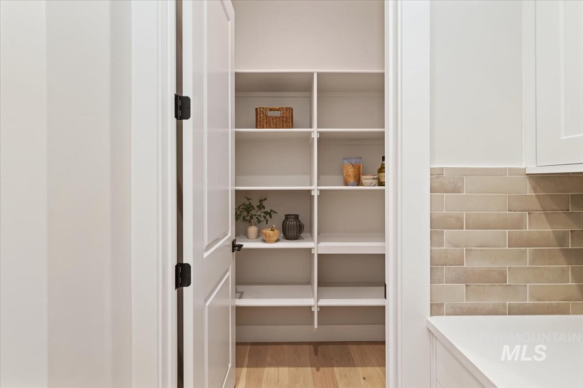 7355 Powell Place Eagle, ID 83714 - Photo 13 of 37 Walk-in pantry featuring extensive white shelving