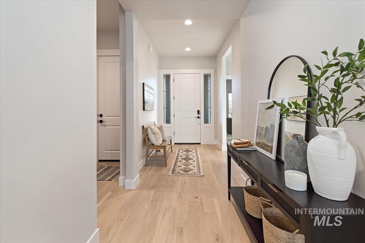 7355 Powell Place Eagle, ID 83714 - Photo 2 of 37 Inviting entryway featuring light wood-finish flooring, recessed lighting, and a solid white entry door with frosted sidelights