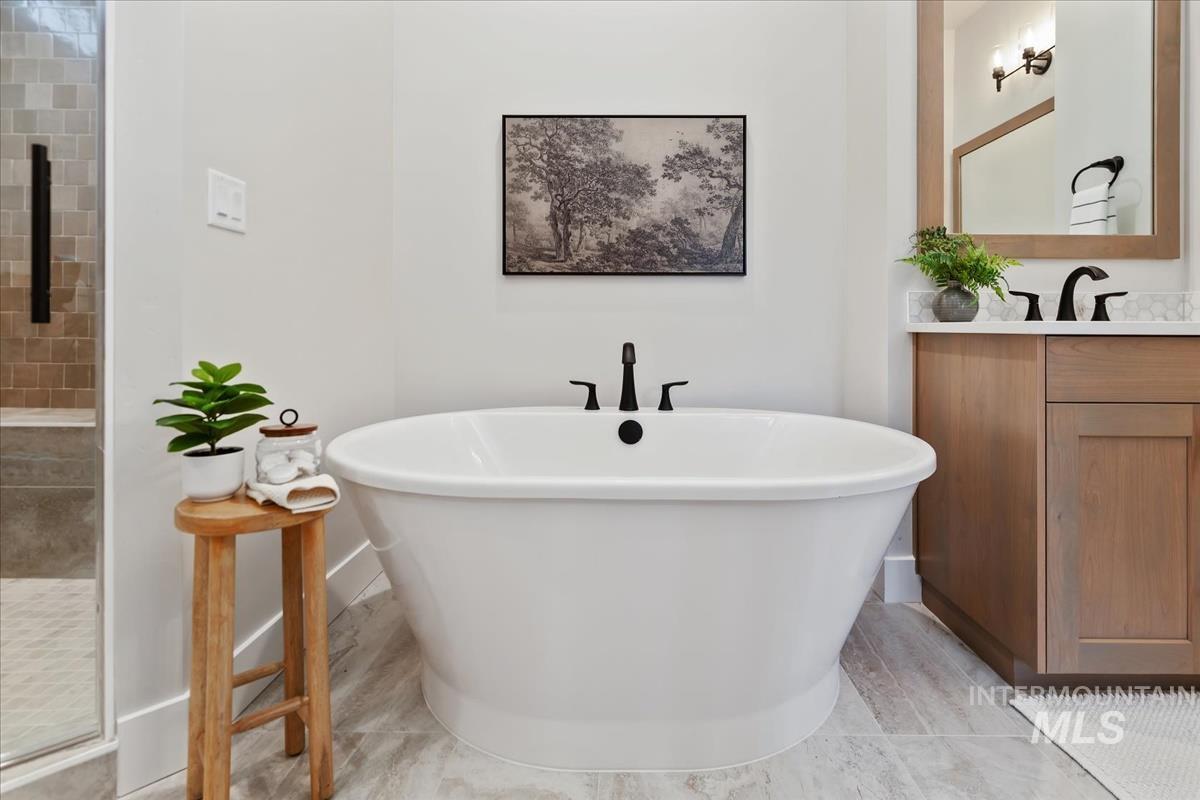 7355 Powell Place Eagle, ID 83714 - Photo 21 of 37 Freestanding soaking tub with matte black fixtures, set against light neutral walls