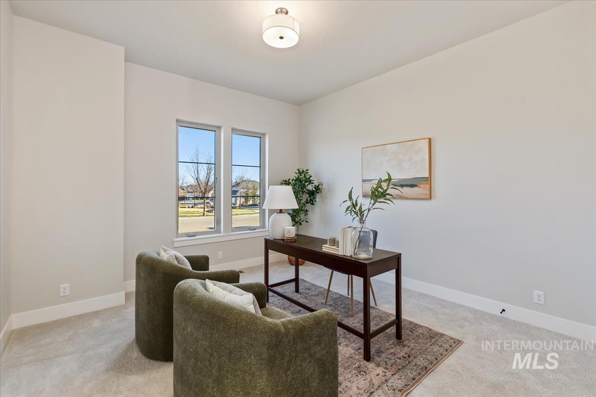 7355 Powell Place Eagle, ID 83714 - Photo 24 of 37 Light-filled room featuring neutral wall paint, white trim, and light-colored carpet flooring