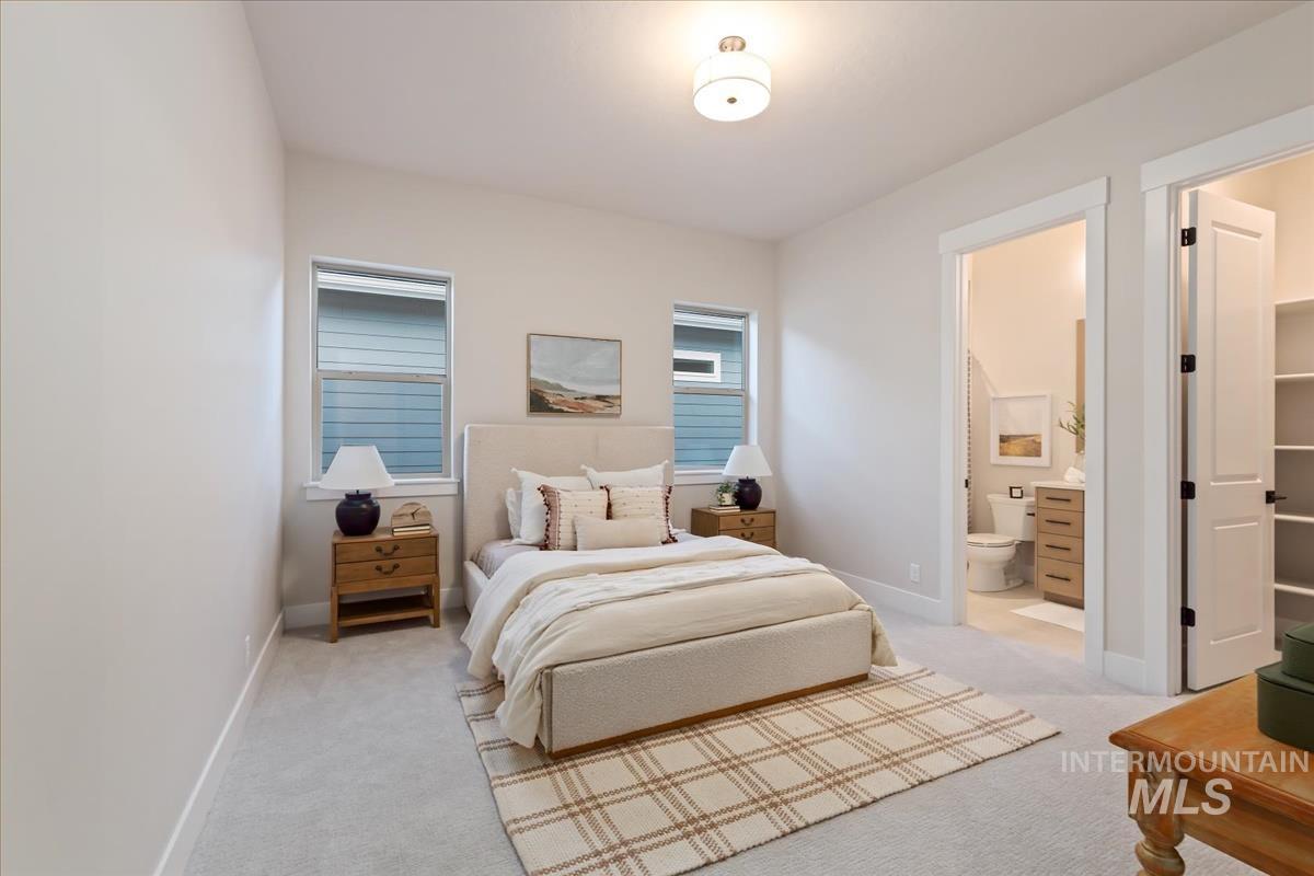 7355 Powell Place Eagle, ID 83714 - Photo 28 of 37 Bright bedroom featuring a flush mount ceiling light, two windows, and light gray wall paint