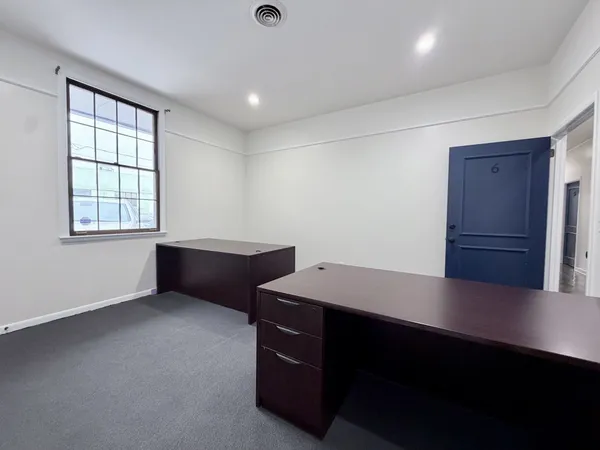 a large white bed in a empty room