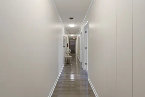 a view of a workspace with furniture and wooden floor