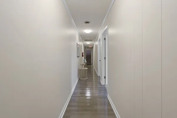 a view of a workspace with furniture and wooden floor