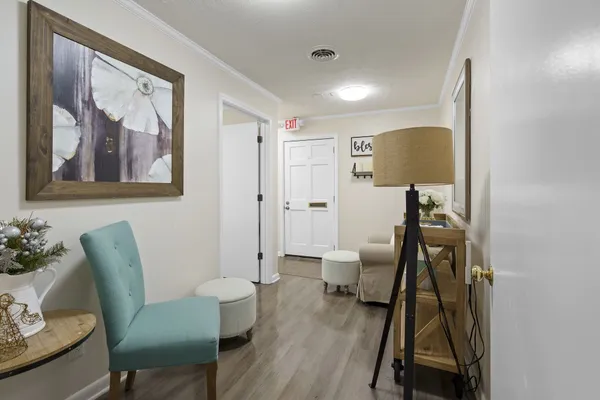 a bedroom with a bed and a wooden floor