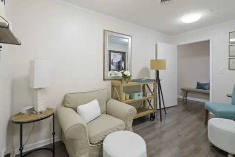 a bathroom with a granite countertop sink a toilet and mirror