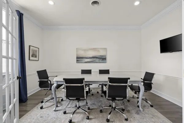 a work room with furniture and a flat screen tv