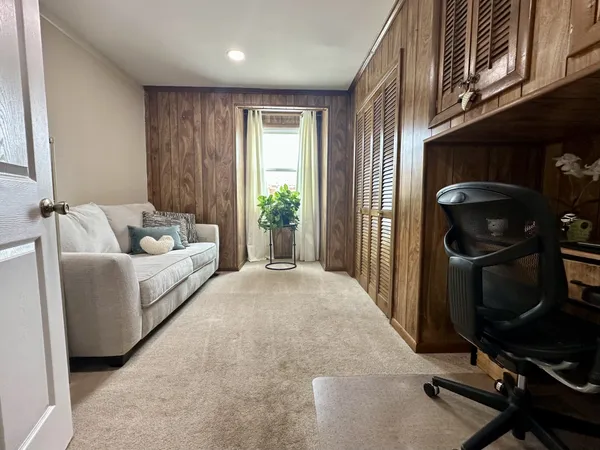 a kitchen with stainless steel appliances kitchen island granite countertop a kitchen island a stove a refrigerator a sink a dining table and chairs