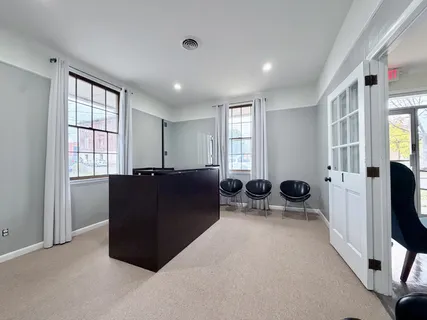 a living room with furniture a flat screen tv and windows