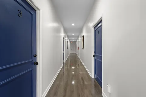 a view of hallway with wooden floor