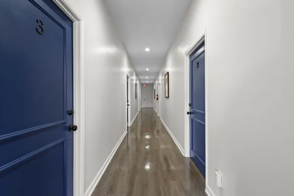 a view of hallway with wooden floor