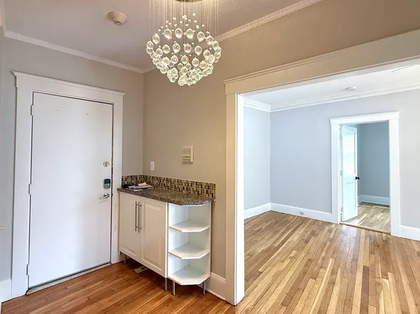 a view of a room with wooden floor