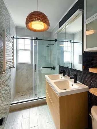 a bathroom with a tub a sink and a mirror