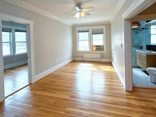 wooden floor in an empty room with a window