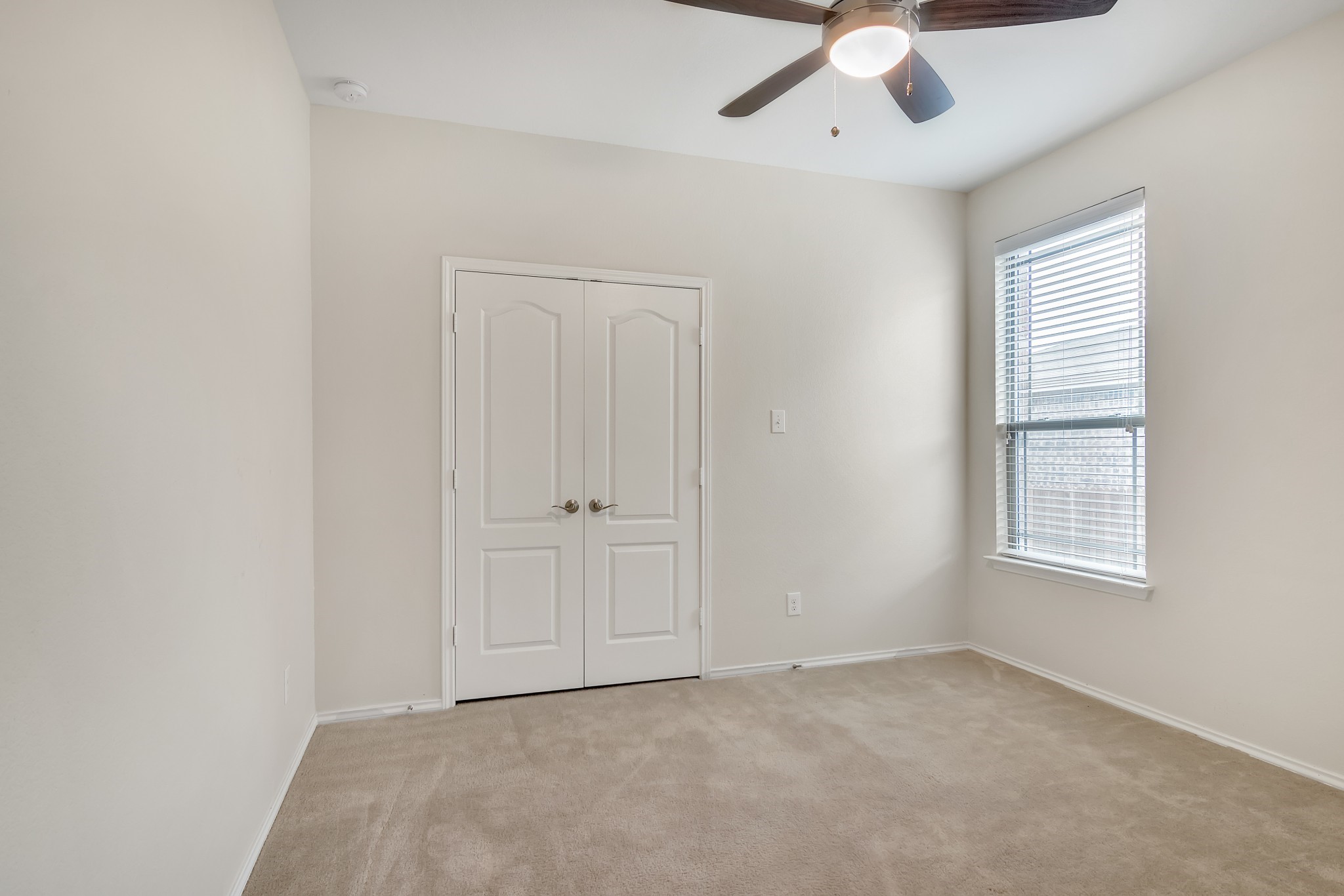 1075 Toltec Trail Georgetown, TX 78626 - Photo 22 of 32 an empty room with windows and ceiling fan