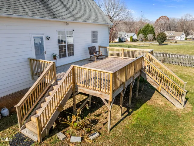 a tree in front of a white house