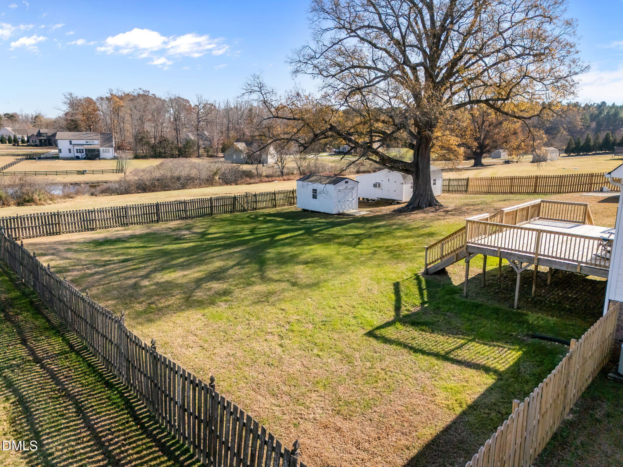 142 Water Front Lane Timberlake, NC 27583 - Photo 39 of 45 a view of a swimming pool with an outdoor seating and a garden