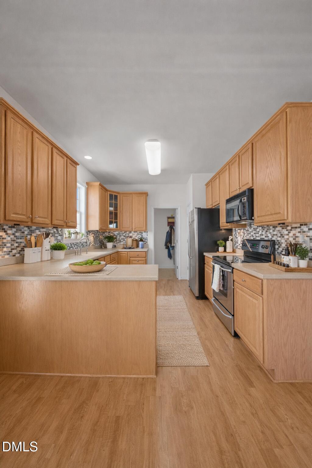 142 Water Front Lane Timberlake, NC 27583 - Photo 6 of 45 a large white kitchen with stainless steel appliances granite countertop a stove a sink a refrigerator and cabinets