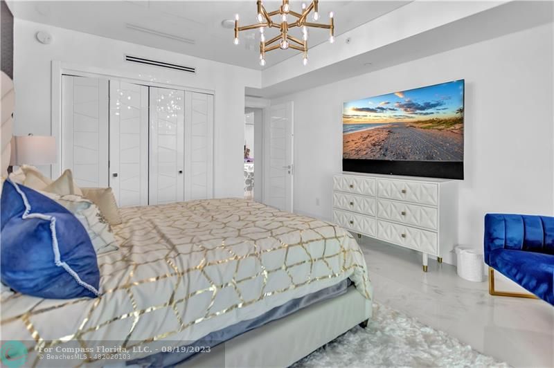 730 North Ocean Boulevard, Unit 503 Pompano Beach, FL 33062 - Photo 28 of 85 a bedroom with a bed and a flat screen tv