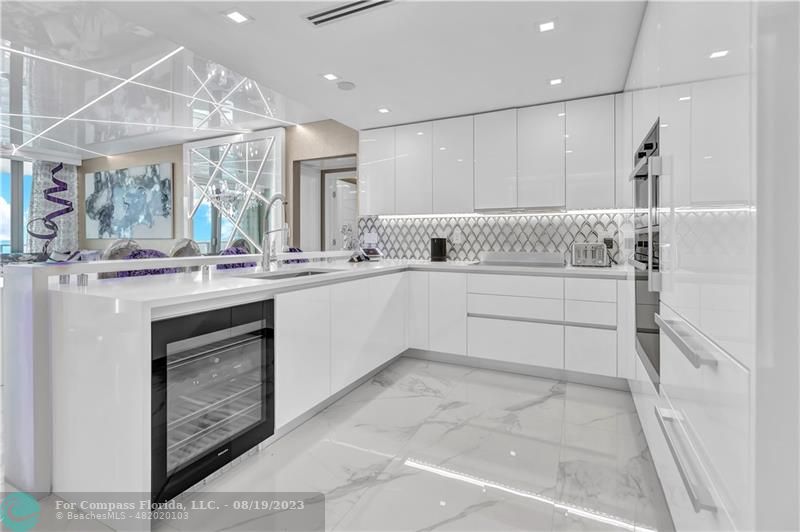 730 North Ocean Boulevard, Unit 503 Pompano Beach, FL 33062 - Photo 4 of 85 a kitchen with a sink stove and cabinets