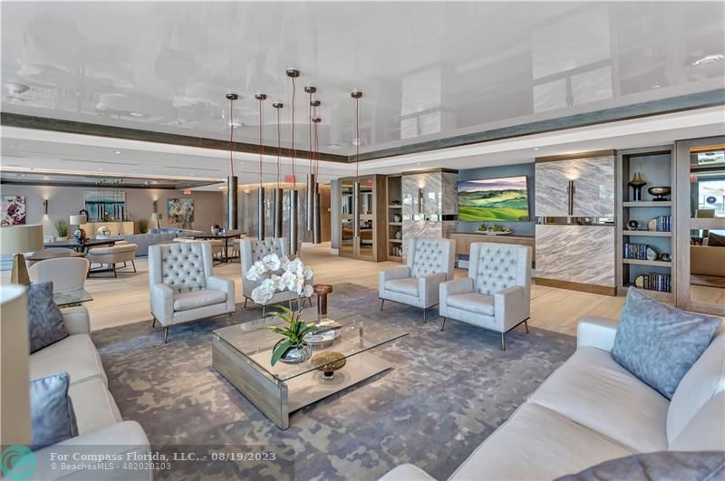 730 North Ocean Boulevard, Unit 503 Pompano Beach, FL 33062 - Photo 61 of 85 a living room with furniture and a chandelier