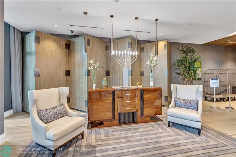 730 North Ocean Boulevard, Unit 503 Pompano Beach, FL 33062 - Photo 75 of 85 a living room with furniture and a chandelier