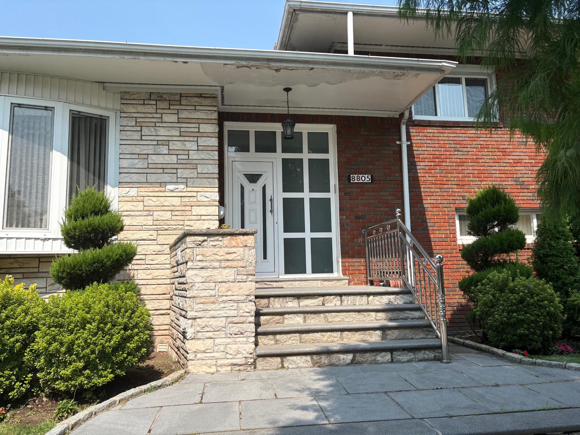 a front view of a house with a garden