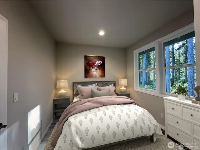 a bed sitting in a bedroom next to a window