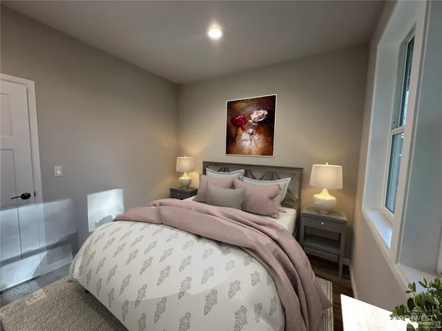 a bedroom with bed and wall painting