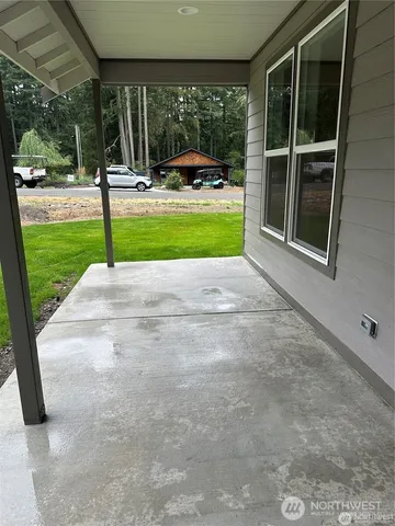 a view of a backyard with floor to ceiling windows and a table