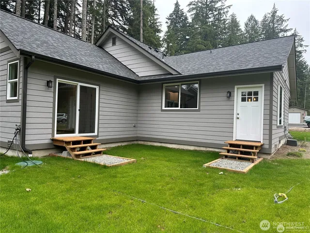 a view of a backyard with a garden and a table and chairs
