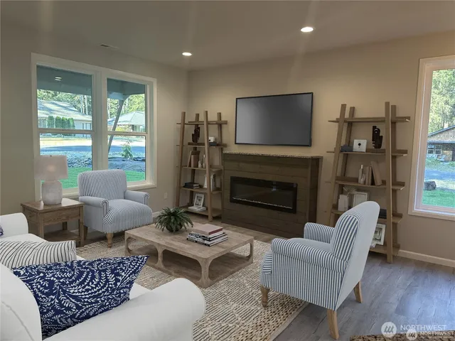 a living room with furniture a flat screen tv and a fireplace