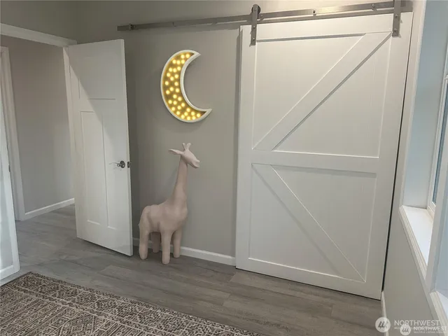 a view of an entryway with wooden floor